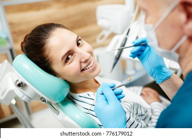 Smiling Patient Of Dentist Looking At Camera During Oral Check-up