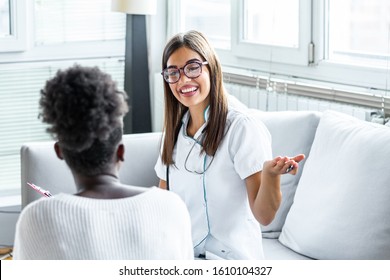 Smiling patient in the doctor's office, she is receiving a prescription medicine, Charming female doctor giving advice to a female patient.