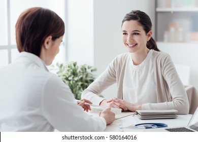 Smiling Patient In The Doctor's Office, She Is Receiving A Prescription Medicine