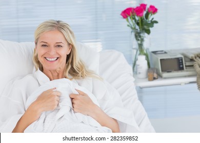 Smiling Patient Looking At Camera On Her Bed In Hospital