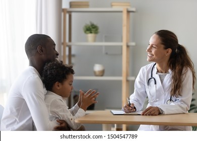 Smiling pediatrician doctor consulting African American father about little son health, smiling dad hugging child, talking to therapist at consultation, children medical insurance care - Powered by Shutterstock