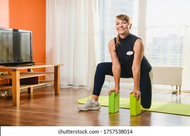 Smiling pensioner woman during morning exercise pose with sport tool - bright foam plastic bricks blocks, retirement healthy lifestyle - Powered by Shutterstock