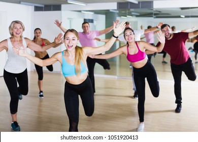 Smiling People Of Different Ages Studying Zumba Dance Elements In Dancing Class