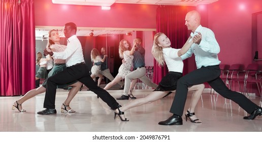 Smiling People Learning To Dance Argentine Tango In Dancing Class..