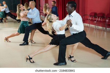 Smiling People Learning To Dance Argentine Tango In Dancing Class..