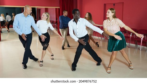 Smiling People Learning Tap Dance Movements In Dancing Class..