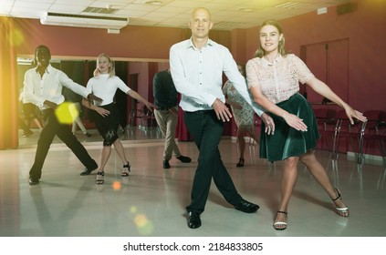 Smiling People Learning Tap Dance Movements In Dancing Class..