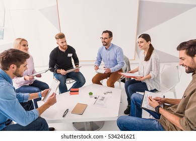 Smiling People Sitting In Circle