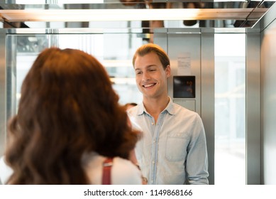 Smiling People Talking In An Elevator