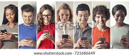 Smiling people using smart phones
