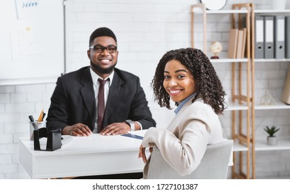 Smiling personnel manager and African American vacancy candidate on job interview in office. Panorama