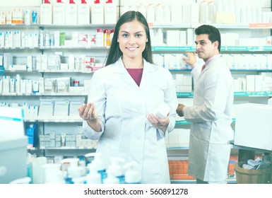 Smiling Pharmacist And Pharmacy Technician Posing In Drugshop