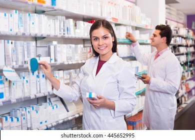 Smiling Pharmacist And Russian Pharmacy Technician Posing In Drugstore