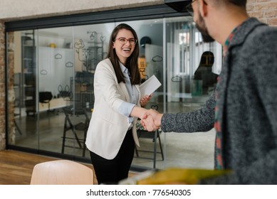 Smiling plainly and firmly handshaking with human resource manager - Shutterstock ID 776540305