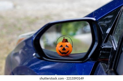 Smiling Plastic Halloween Pumpkin Mini Small Pumpkin In Reflection Rear View Retractable Lateral Mirror.woman Hand Holding Pumpkin Bucket Handle.trick Or Treat Holiday, Car Auto Vehicle Vehicle Part
