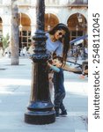 A smiling playful two year old shares a loving moment with his mother at the historic fountain in Plaza Real in Barcelona, Spain, at the Gothic Quarter	