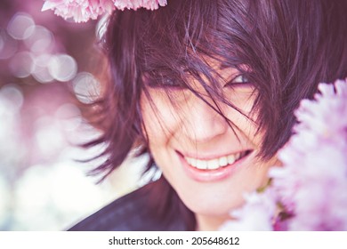 Smiling Playful Woman And Spring Blossoms