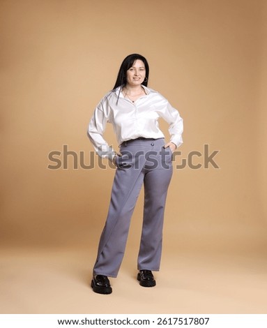 Smiling plus size model on beige background. Overweight