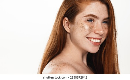 Smiling plus size woman, looking happy, has under eyes patches, glitter on face, standing over white background - Powered by Shutterstock