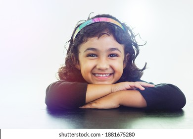 Smiling Portrait of Little Girl Wearing a Colorful Headband, Isolated, White