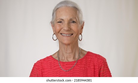 Smiling Portrait Of Mature Woman Doctor Talking Over Video Chat To Patient On Tele Health Consultation.