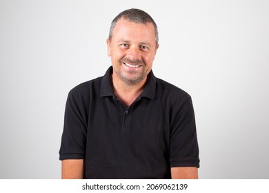 Smiling portrait middle aged man isolated on black shirt and white grey background - Shutterstock ID 2069062139