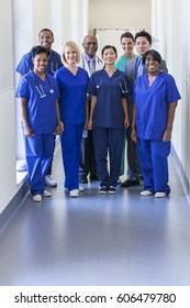 Smiling Portrait Multi Ethnic Team In Uniform Providing Healthcare Treatment And Patient Diagnosis In Modern Medical Facility