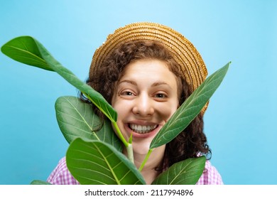 Smiling. Portrait Of Young Pretty Girl, Female Gardener In Work Uniform Watering Flower Isolated On White Background. Concept Of Job, Emotions, Agronomy. Funny Meme Emotions. Copy Space For Ad