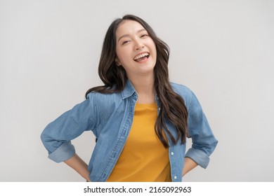 Smiling positive, attractive asian young woman wearing casual dress, portrait of beautiful brunette her with long brown hair, feeling happy looking to camera standing isolated on white background.