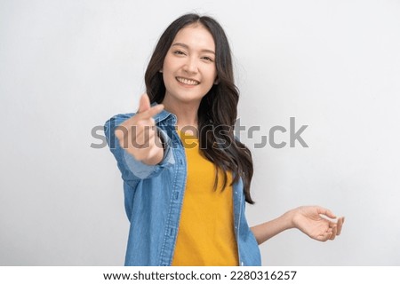 Smiling positive, attractive asian young woman finger showing mini heart sign, portrait of beautiful brunette hair with long hair. Cheerful, expression face happy standing isolated on white background