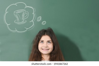 Smiling Pre-adolescent Child  Dreams About Cup Of Tea On Green School Board Background. 