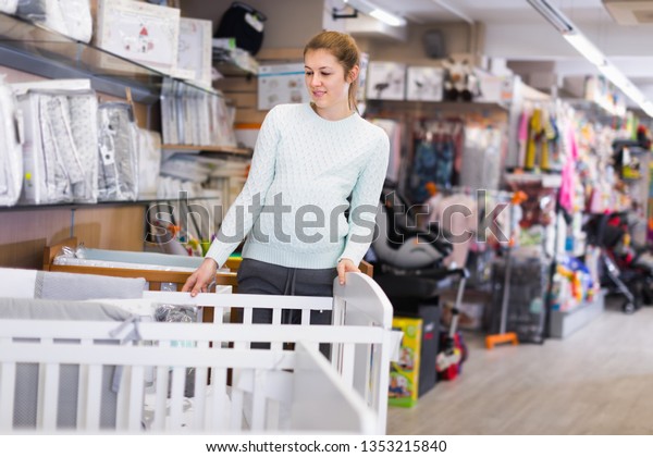 Smiling Pregnant Woman Choosing New Crib Stock Photo Edit Now