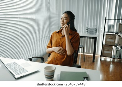 Smiling Pregnant Woman Talking on Phone in Modern Office - Powered by Shutterstock