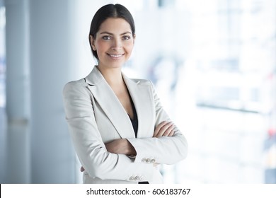 Smiling Pretty Business Woman With Arms Crossed - Powered by Shutterstock