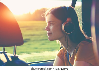 Smiling Pretty Girl Listening To Music With Headphones Moving In Car