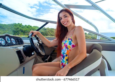 Smiling Pretty Girl With Long Red Hair In Cool Colourful Swimwear Riding And Sailing Luxury Boat On Holiday, Face And Body Side View, Sitting Bikini Woman Sexy Boat Captain Enjoys Tropical Vacation