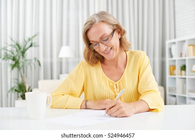 Smiling Pretty Mature Woman Writing A Letter