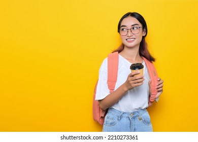 Smiling Pretty Young Student Girl Wearing Backpack And Glasses Holding Takeaway Coffee Cup Isolated On Yellow Background