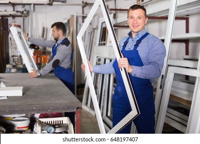 Smiling Production Workers In Coverall With Different PVC Windows And Doors