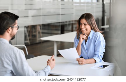 Smiling professional female hr having job interview meeting with male recruit. Happy middle aged business woman financial advisor, bank manager consulting client working in office. Candid photo - Powered by Shutterstock