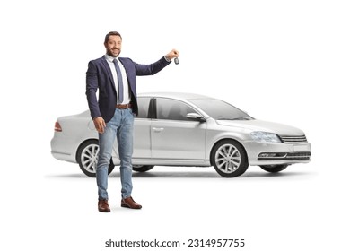 Smiling professional man holding a car key in front of a sliver car isolated on white background - Shutterstock ID 2314957755