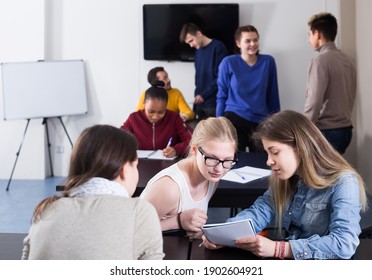 Smiling Pupils Having Conversation At Recess In School