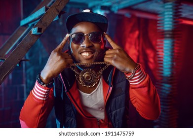 Smiling Rapper With Gold Chain Posing In Studio