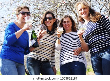 smiling real mature women is holding champagne glasses - Shutterstock ID 1303982197