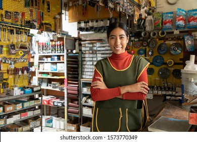 Smiling Real Worker Attending A Hardware Store. Interior Detail