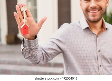 Smiling Realtor Standing Outside Modern House