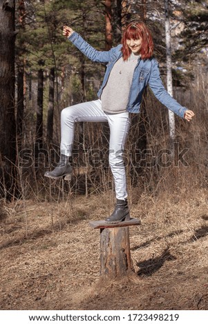 Similar – Woman walking on a fallen tree trunk