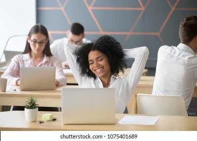 Smiling Relaxed African American Woman Resting After Computer Work In Office Hands Behind Head, Happy Black Employee Student Enjoying Break Stretching Feeling No Stress Free Relaxing In Coworking