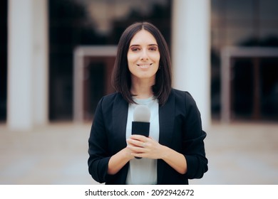 
Smiling Reporter Holding A Microphone Ready To Broadcast. Happy Cheerful Professional Journalist Reporting On Field
