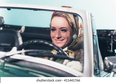 Smiling Retro 1960s Fashion Woman With Headscarf Driving Sports Car.